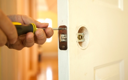 Handyman in Monticello, GA fixing door.